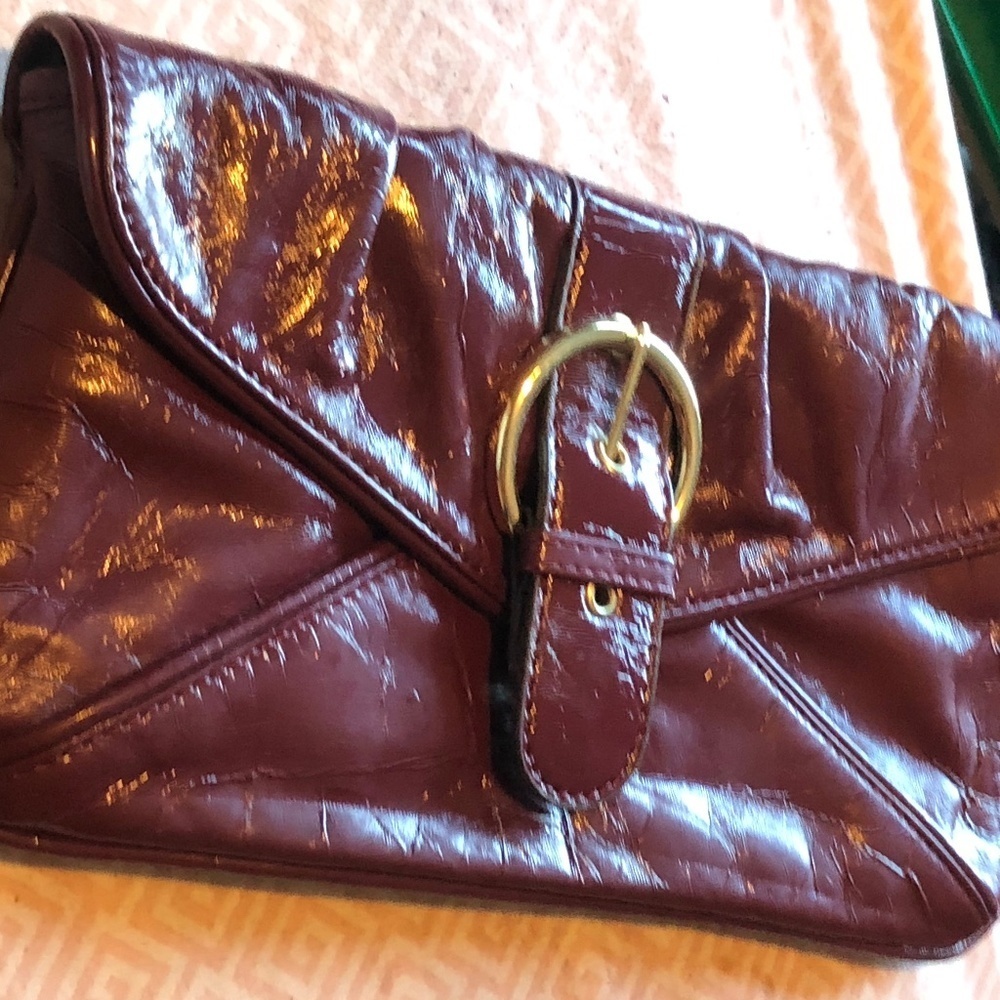 MONDANI New York burgundy clutch purse, stylish, clean , slightly used